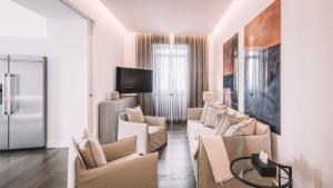 a living room with white furniture and a tv at TORRINHA PANORAMA WOHNUNG in Funchal