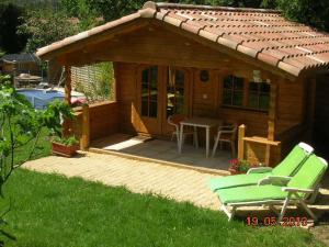 a small cabin with a table and chairs in a yard at Chalet l'emiline , Gite climatisé au sud d'aix avec piscine in Bouc-Bel-Air