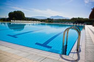 a large swimming pool with blue water at Life Sport Hotel in Mentana