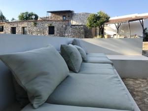 a white couch with pillows sitting on a wall at Charming Apartment with Jacuzzi and Sea View - Salve, 85 sqm in Salve