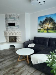 a living room with a couch and a table at Zum Geigenmüller in Stützengrün