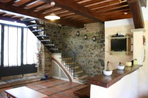 a staircase in a room with a stone wall at Casa di Pino in Polvano