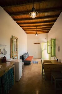 a living room with a couch and a table at Simboro house - Kythoikies holiday houses in Kythira