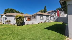 a house with a large lawn in front of it at 4 bedroom house in Glenhazel for family, friends and leisure in Johannesburg