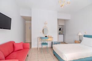 a bedroom with a bed and a couch and a table at Arolithos in Spetses