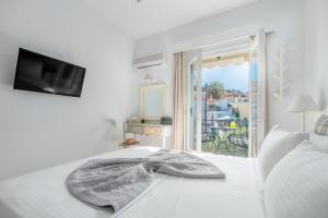 a bedroom with a bed with a blanket on it at Arolithos in Spetses