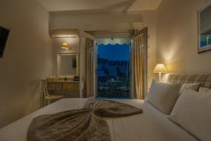 a bedroom with a bed with a towel on it at Arolithos in Spetses