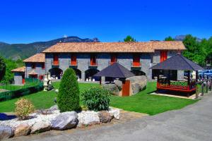 a large building with a red and white at Casas Ordesa y Casa Altemir in Belsierre
