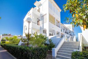 a white building with stairs in front of it at MI PERLA in Torrevieja