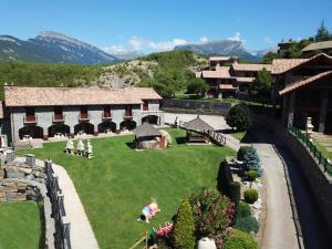 a view of a building with a green yard at Casas Ordesa y Casa Altemir in Belsierre +6 photos