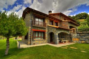 a stone house with a table in front of it at Casas Ordesa y Casa Altemir in Belsierre