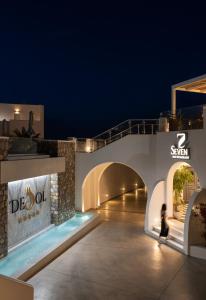 a person walking through a tunnel at night at De Sol Hotel & Spa in Fira