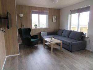 a living room with a couch and a chair and a table at Mosas cottages in Fludir