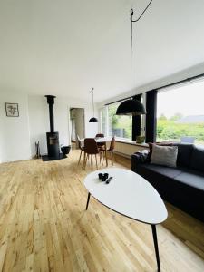 a living room with a couch and a table at aday - Quiet and cozy house in Aalborg