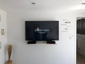 a flat screen tv sitting on a wall at - Loft fléchette - clim - garage in Laplume
