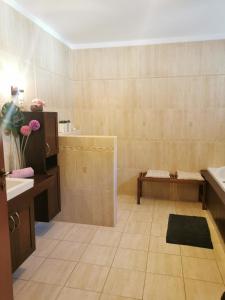 a bathroom with a sink and a toilet and a tub at Mediterrán Vendégház in Balatonőszöd