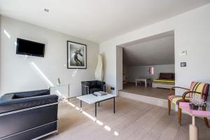 Телевизор и/или развлекательный центр в La Loge de mer, Lodge urbain