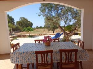 a table with a blue table cloth on a patio at Tenuta Cazzato in Lido Marini