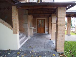 a brick walkway leading to a door of a house at Pension La Campagna in Hrádek nad Nisou +21 photos