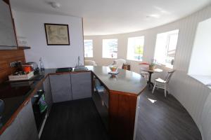 a kitchen with a counter and a table in a room at Admiral Quarters in Dartmouth