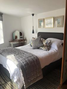 a bedroom with a large bed with pillows on it at Admiral Quarters in Dartmouth