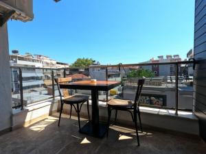 a table and chairs on a balcony with a view at Alâ Avsa Hotel in Avşa Adası