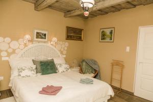 a bedroom with a bed with a white bedspread at Szívem Csücske Vendégház in Nagybörzsöny