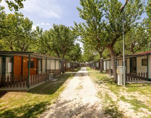 a row of houses on a dirt road at Camping Classe in Lido di Dante