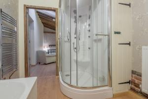 a bathroom with a shower with a glass door at Court Barn in Stoke-by-Nayland