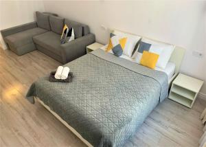 a bedroom with a king sized bed and a couch at Iris apartment on Popovich in Lviv