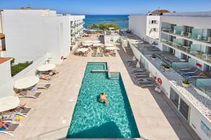 an overhead view of a swimming pool at a resort at Hotel Ilusion Moreyo - Adults Only in Cala Bona