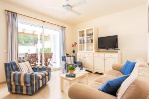 a living room with two couches and a tv at Villa Las Mariposas by Villa Plus in Es Mercadal