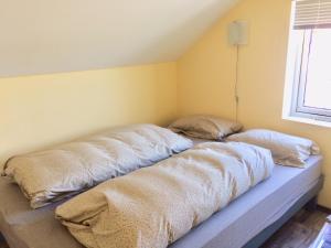 two pillows on a bed in the corner of a room at tau bed and breakfast in Strand