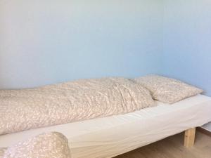 two pillows sitting on top of a bed in a room at tau bed and breakfast in Strand +3 photos