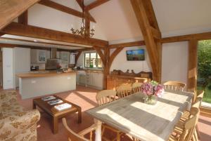 a kitchen and dining room with a table and chairs at Hirons Piece in Weston Subedge