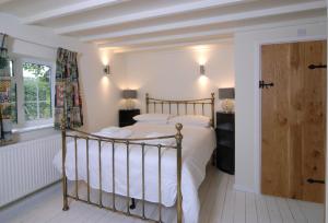 a bedroom with a bed with a wooden frame at Hirons Piece in Weston Subedge