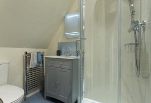a bathroom with a shower and a sink at Upper End House in Shipton under Wychwood +17 photos