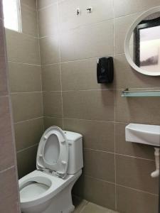 a bathroom with a toilet and a mirror and a sink at Cheras-Miharja Homestay @Sunway Velocity in Kuala Lumpur +16 photos