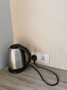 a tea kettle plugged into an electrical outlet at Cheras-Miharja Homestay @Sunway Velocity in Kuala Lumpur