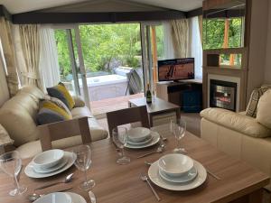 a living room with a table with plates and wine glasses at V13 - The Falls with Hot Tub in Bethesda