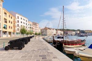 a group of boats docked in a harbor with buildings at Valentino in Senj
