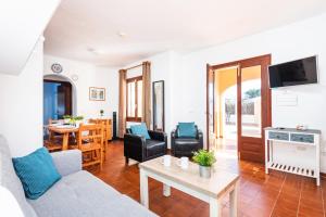 a living room with a couch and a table at Villa Matias Maria by Villa Plus in Cala en Blanes