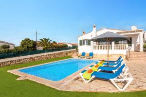 a swimming pool with two lounge chairs and an umbrella at Villa Santi II by Villa Plus in Cala'n Porter