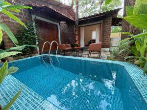 a pool in the backyard of a house at Cheerful 2-Bedroom Villa with Private Plunge Pool, Candolim, Goa in Marmagao