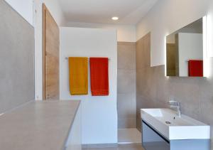 a bathroom with a white sink and colorful towels at Ferienwohnungen Am Aller-liebsten in Düngenheim +23 photos