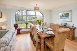 a dining room with a table and a couch at Dignity in Galashiels