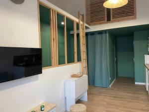 a living room with a flat screen tv on a wall at Superbe appartement La Rochelle in La Rochelle