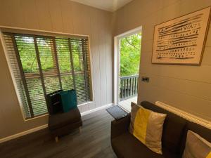 a living room with a couch and a window at P56 - Studio Pod with Hot Tub in Bethesda