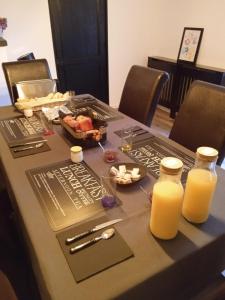 a table with two bottles of orange juice on it at la petite Poyannaise in Poyanne