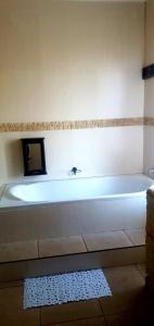 a white bath tub sitting in a bathroom at Sun view in Nelspruit